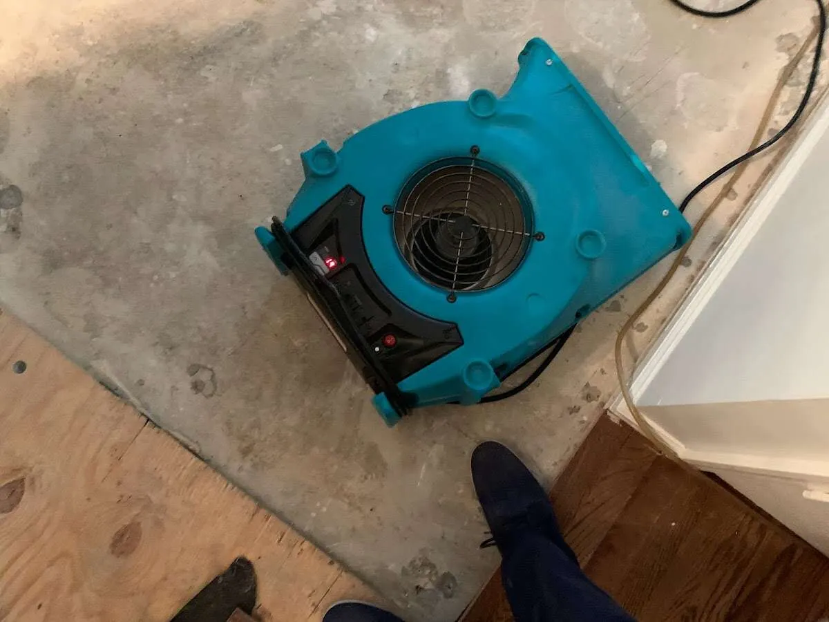 Air mover drying subfloor during Commercial Water Damage Restoration in Closter